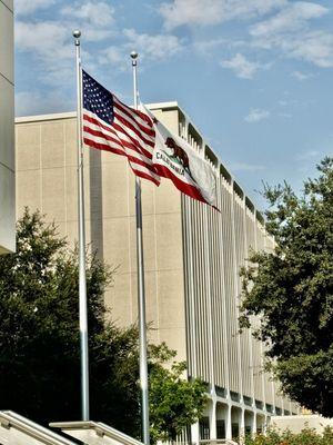 Flags flowing in front of building