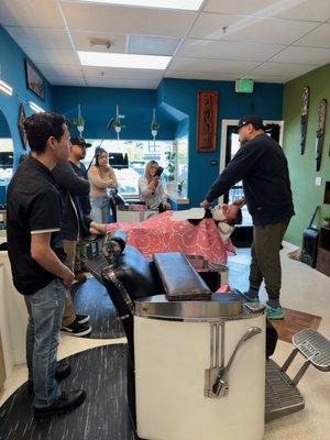 Shaving training for the Barbers. Continuing education is a big part of our culture.