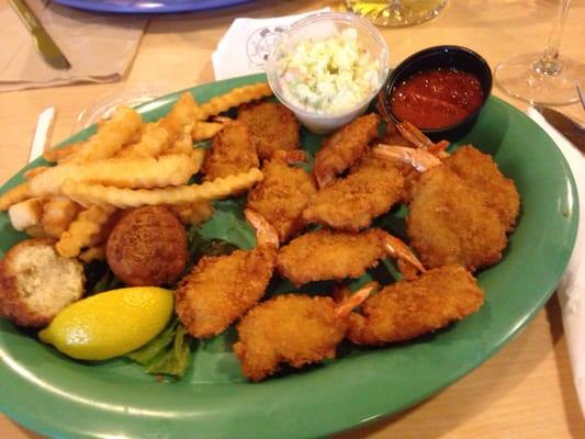 Fried shrimp French fries hush puppies and coleslaw.