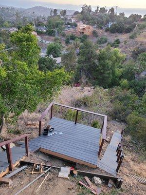 3 sets of stairs totalling 61 treads and risers with a deck after the first set of stairs.