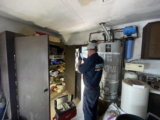 Technician removing a tank and installing a tankless and a halo five filtration & Conditioning system