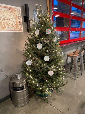 Big Trout Brewing Christmas tree with hand-drawn paper ornaments.