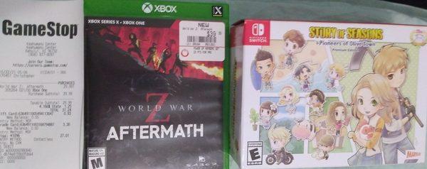 GameStop receipt, World war Z, and Story of seasons Pioneers of Olive Town Premium Edition.