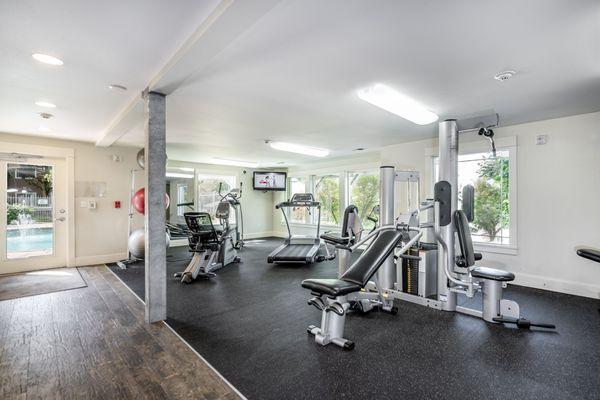 Get your workout with a view! Our fitness center offers panoramic vistas of lush greenery and our pool, inspiring your wellness journey.