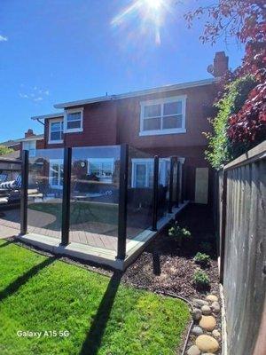 Custom wind resistant glass barrier for deck. Installed posts into concrete.