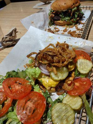 Black bean burger top and turkey burger with onion strings and extra everything bottom