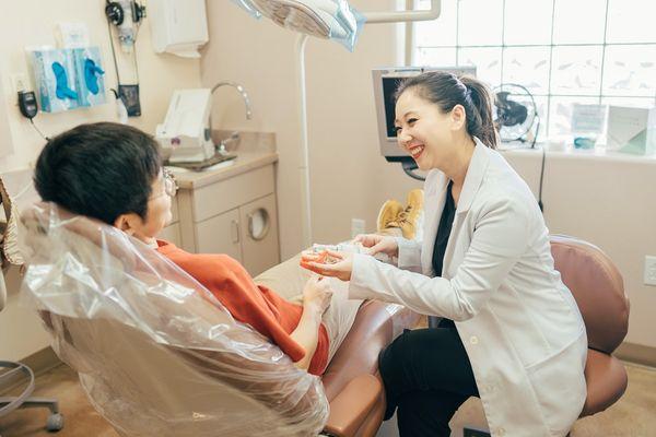 Tucson dentist Dr. Sarah Kym explaining dental implants to patient at Prime Dental