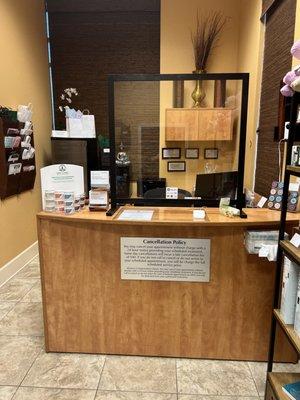 Our reception desk featuring our favorite products on the counter