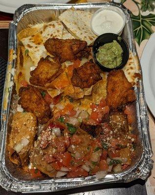 Sampler platter (taquitos, nachos, cheese quesadillas n buffalo wings). Topped with Pico de Gallo, sour cream n guacamole on the side