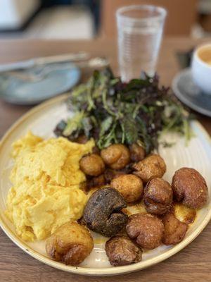 Two eggs any style with a side salad and smashed crispy potatoes