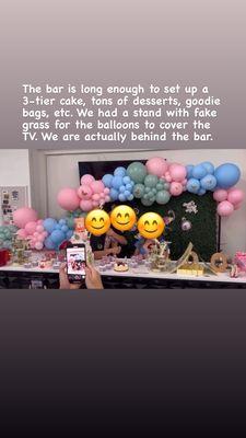 The bar (and the TV behind the balloons & fake grass).