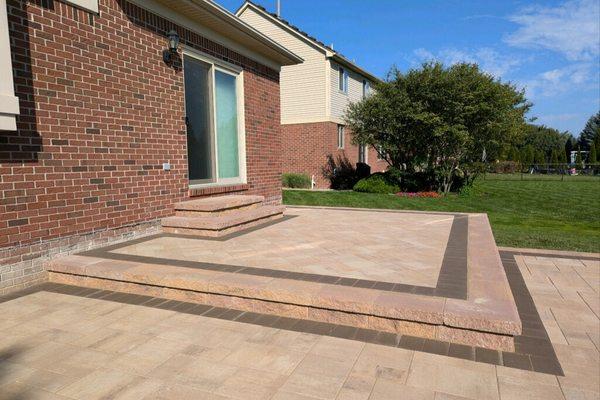 Macomb Twp project. Raised brick paver patio and brick paver walkway.  Retainer wall is Fendt, Keystone Compact Brick is Belg...