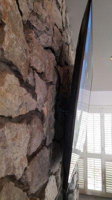 Uneven stone surfaces are more difficult to mount to than normal drywall. Don't try this yourself!