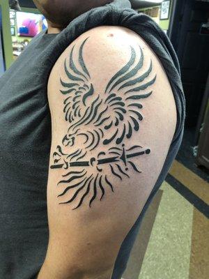 My Nephew's name is Phoenix, so he wanted a tattoo to reflect that. Phoenix with sword in it's talons.