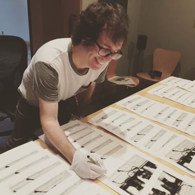 Musician/Photographer Ben Folds signing prints for limited edition vinyl release.