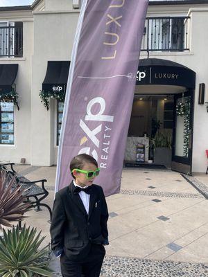 Little gentleman out and about, rocking a suit with green shades that steal the show!