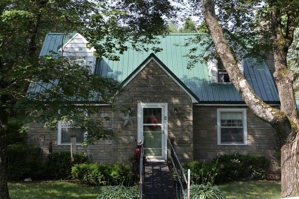 The greenery around this home, really makes the roof pop!