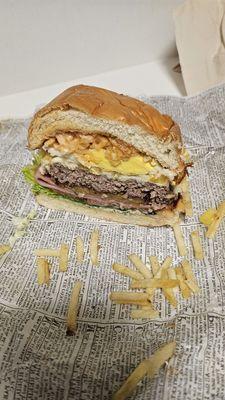 Beef Explosion Burger cut in half to see the many layers