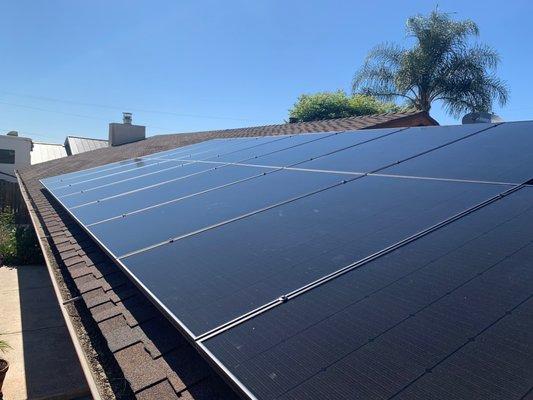 The finished solar panels layed on a client's shingles roof in Tarzana