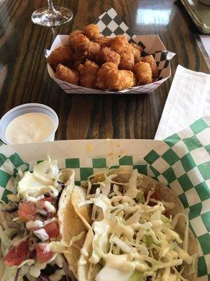 Spicy pork taco, mahi mahi taco and tator tots