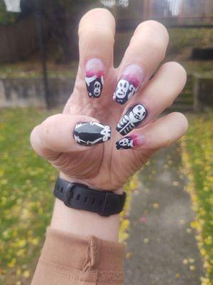 Halloween nail design with his and her skeleton.