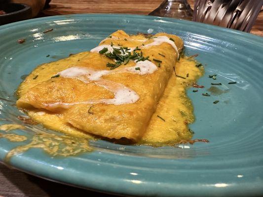 Two chicken enchiladas with cheese sauce