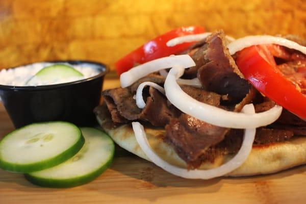 Gyros: Thinly sliced Beef and Lamb. Served on a Pita with Tomatoes, Onions and our Homemade Tzatziki Sauce.