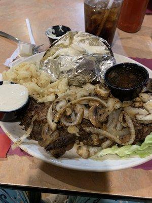 Prime rib with Mac n cheese, baked potato and topped with onions and mushrooms