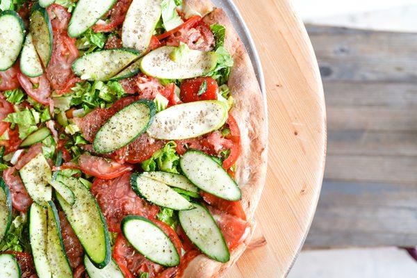 Salad Pie topped with seasoned cucumbers, tomato and lettuce