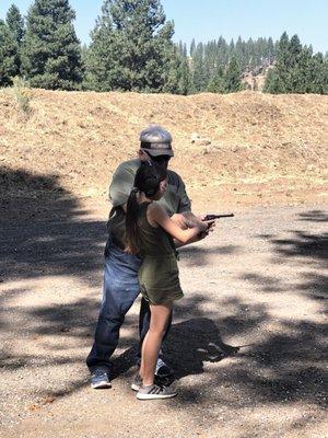 Grandpa teaching grand daughter to shoot