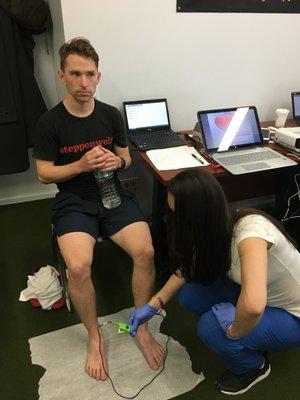 A YMCA basketball player having an ABI test performed by one of our Medical Assistants