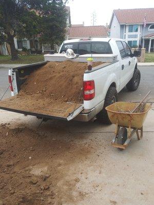 Adding dirt to level off yard so we can pour cement