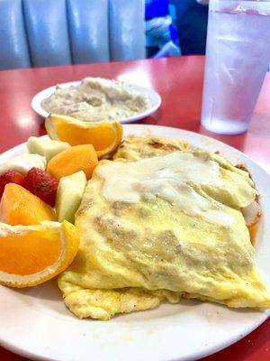 Guido omelette filled with linguisa sausage, marinara and mozzarella cheese accompanied by fruit and biscuit and gravy.