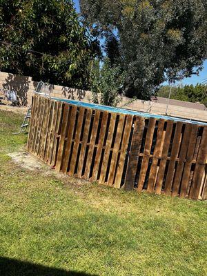 Framed the outside of our above ground pool with pallets