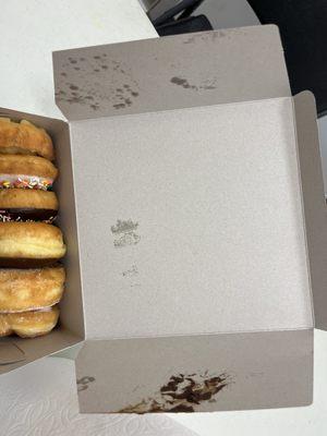 Her repeated attempts to shove the lid into place damaged a donut. Thank goodness the other side had the donut's glaze facing inward.