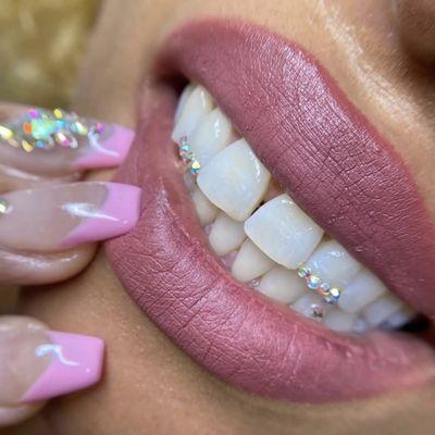 Teeth whitening, nails, and tooth gem.