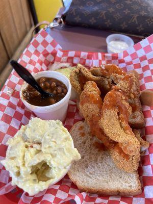 Catfish filet, potato salad, and baked beans.