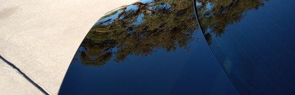 The reflection of the sky on the vehicle's Hood