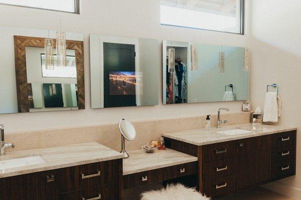 A mirror TV is the perfect solution for saving countertop space in a bathroom.