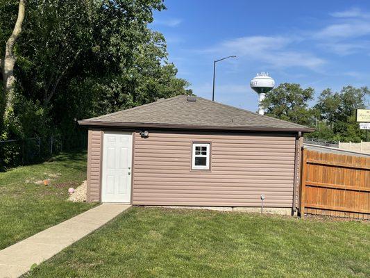 BEFORE- the ugly brown and the garage siding was not properly installed.