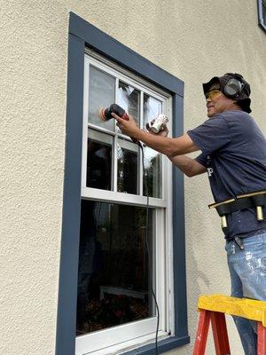 Jeff Kim of JK Window Cleaning buffing a double-paned window