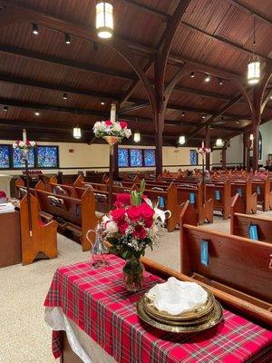 Beautiful floral arrangements for the pew candled.