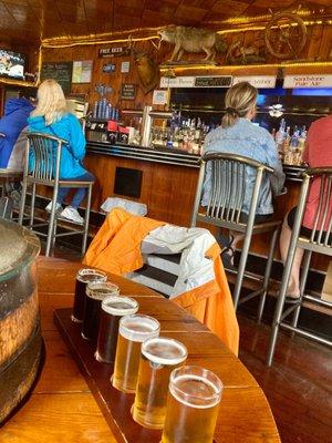 Beer flight with the bar behind.