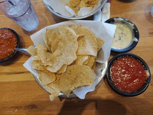 Chips salsa, hot salsa and white queso