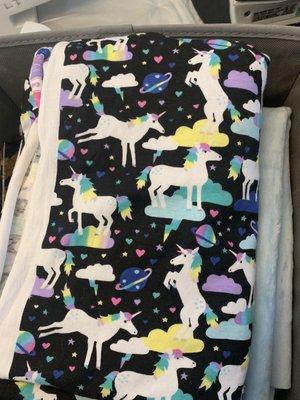 Unicorn fabric with hearts, planets, and clouds.