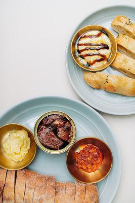 Two of the small plate options: conservas plate (with chili crisp smoked salmon) and the buratta & foccaccia dish (with balsamic & truffle)