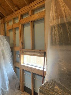 My kitchen cabinets were removed along with the wet insulation and Sheetrock. Plastic was used to help with dust. Great job!