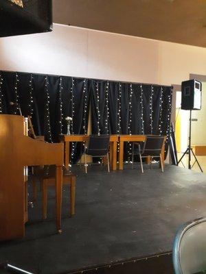 Performing stage that's converted to additional lounge/study space.