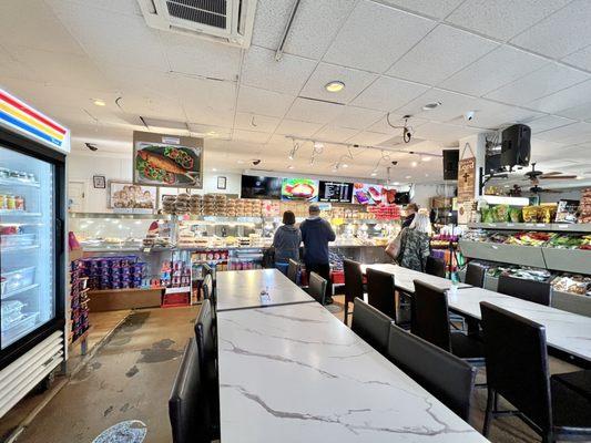 Another dining area near the food display cases.