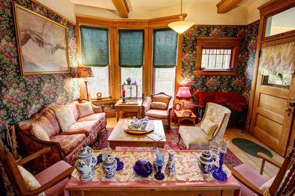 View to the east, main floor living room, with historic furnishings, from a 19th century local bordello.